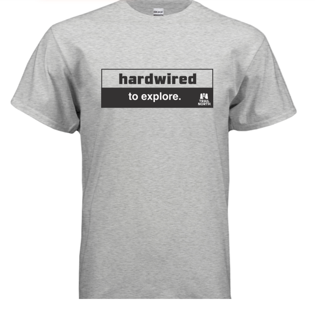 Gray t-shirt with 'hardwired to explore.' text on a white background