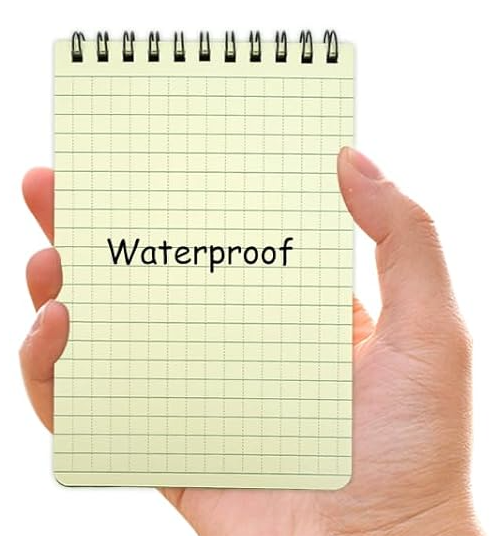 Hand holding a notepad with 'Waterproof' text on a white background