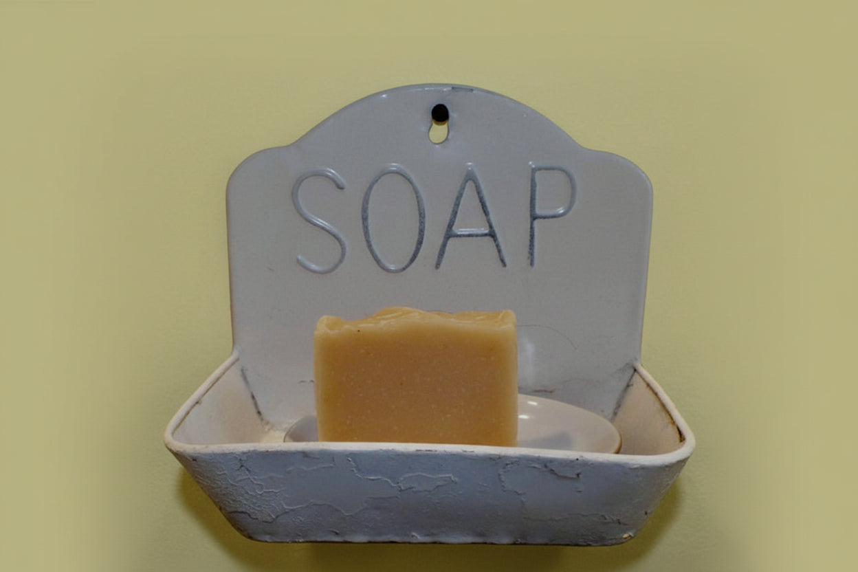 Soap dish with a bar of soap on a yellow background
